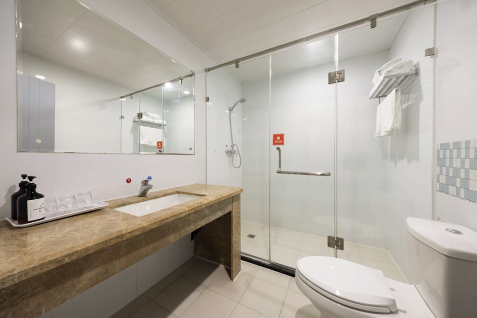 Shower, hair dryer, slippers, towels