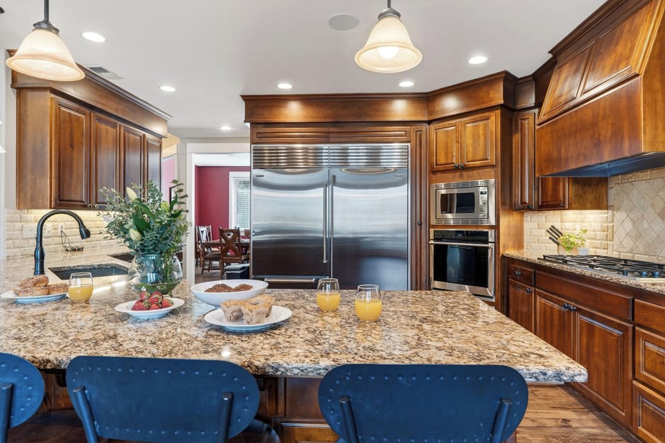 Whip up home-cooked favorites in the chef’s kitchen—granite island seating, stainless steel appliances, and plenty of space to gather.