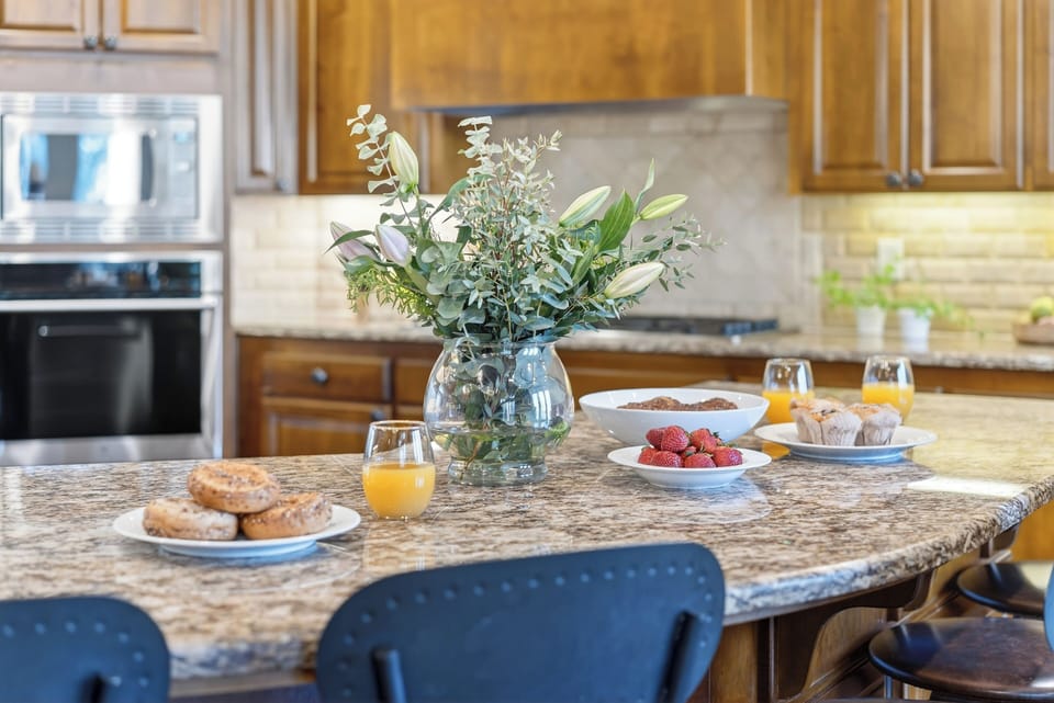 Whip up home-cooked favorites in the chef’s kitchen—granite island seating, stainless steel appliances, and plenty of space to gather.