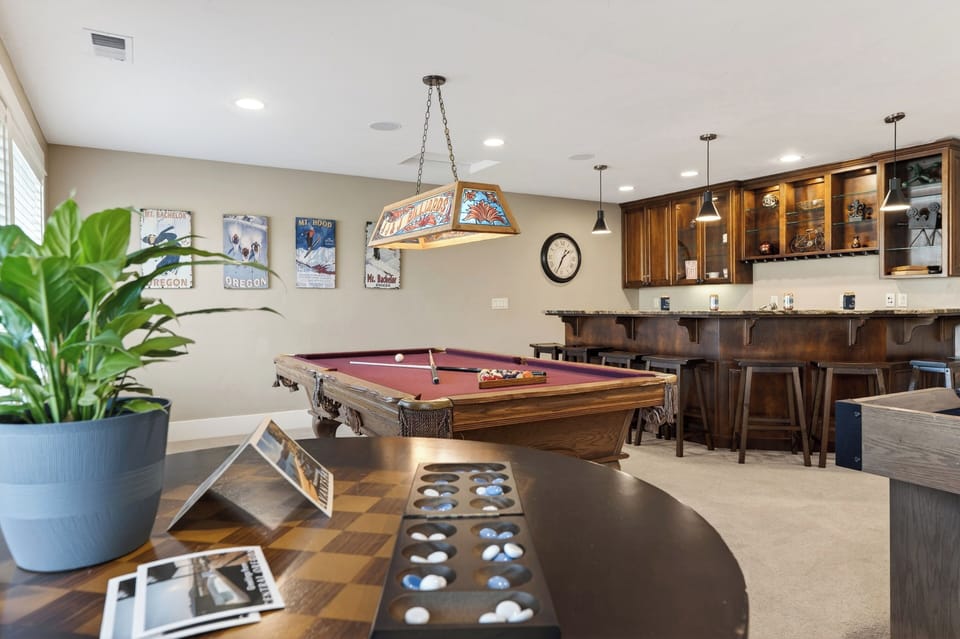 Game on in the bonus lounge—foosball, shuffleboard, pool table, cozy sectional, and a fireplace for post-play hangouts.