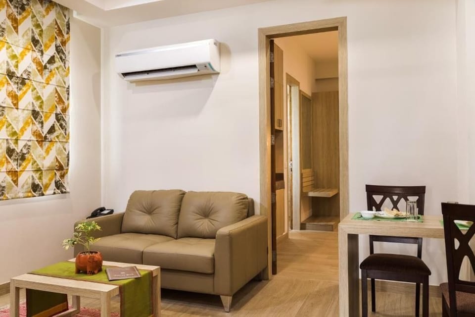 Family Suite, City View | Living area | TV