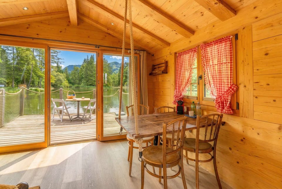 Bright wooden interior with dining area and access to the private terrace