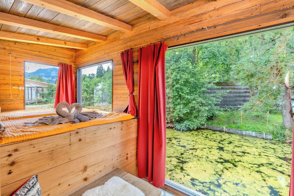 Sleeping area with large windows and direct nature view