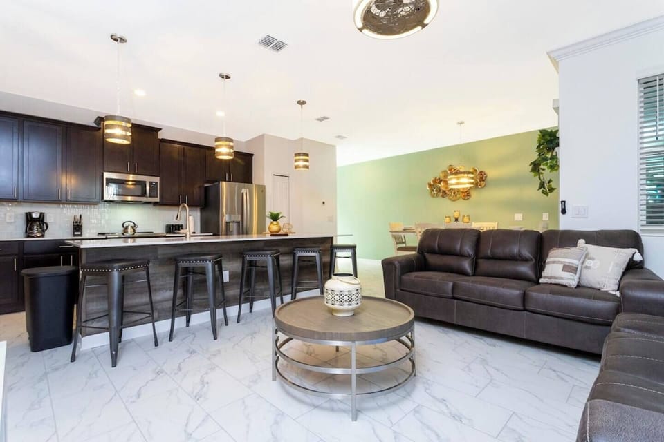 Open living space that seamlessly connects the beautiful kitchen and dining area, offering a perfect blend of comfort and style.