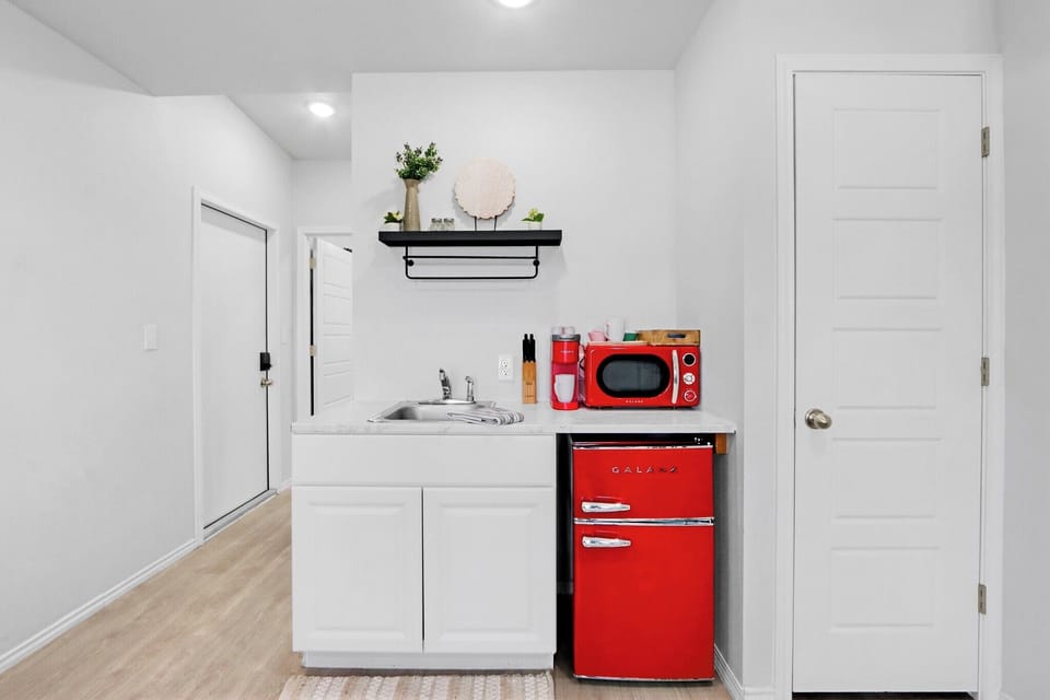 The kitchenette features bright red retro appliances