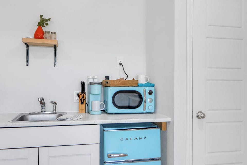The kitchenette features bright retro appliances