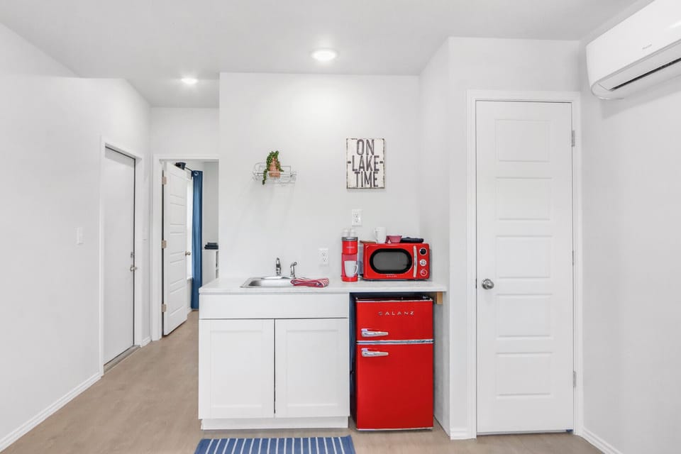 Kitchenette features a mini fridge and microwave