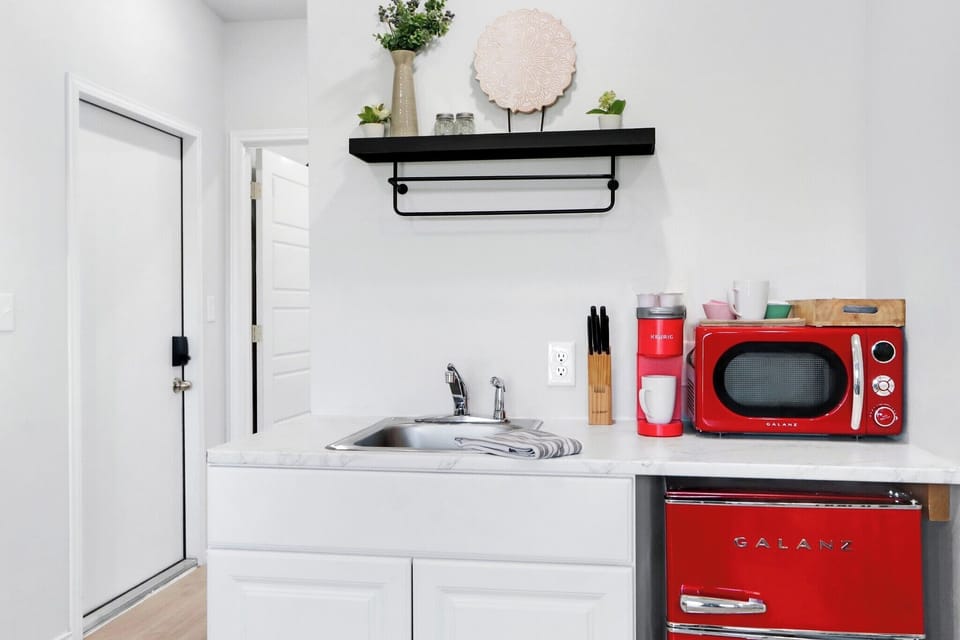 The kitchenette features bright retro appliances