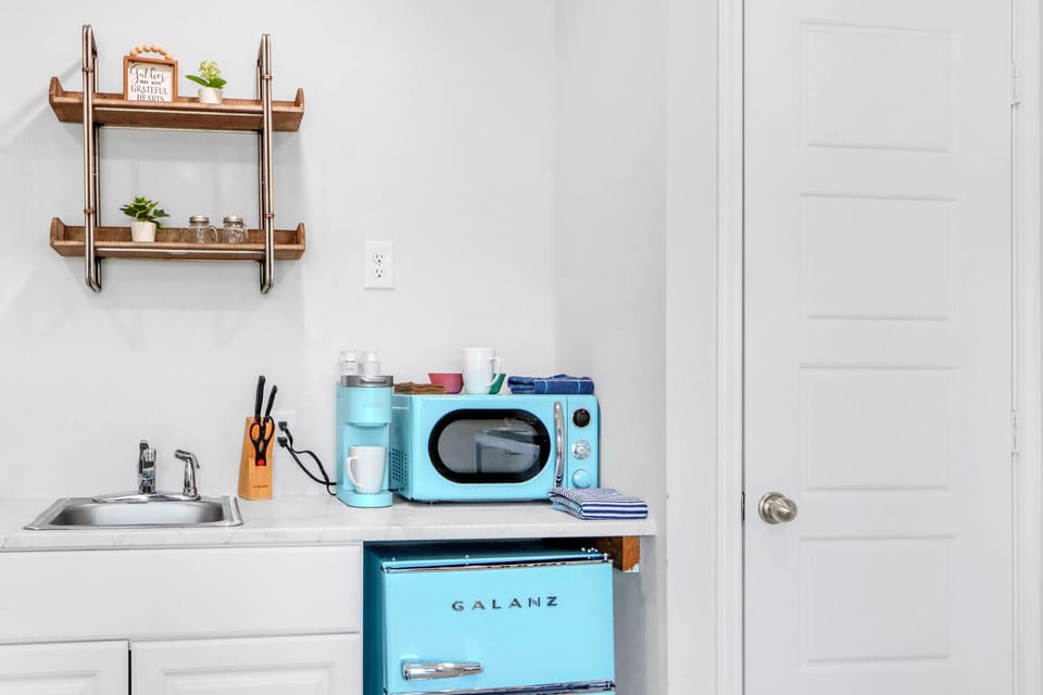 The kitchenette features bright retro appliances