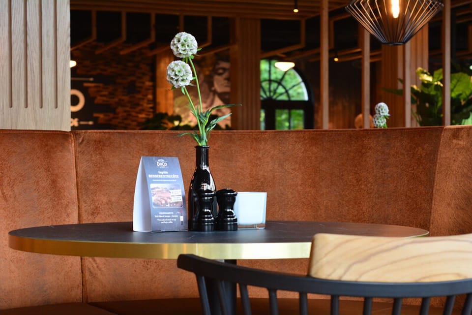 Lean in for intimate cocktails at a cozy corner banquette.