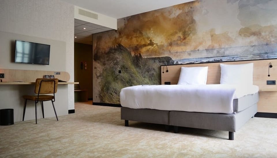 Unwind in a bright king room with dramatic mural backdrop.