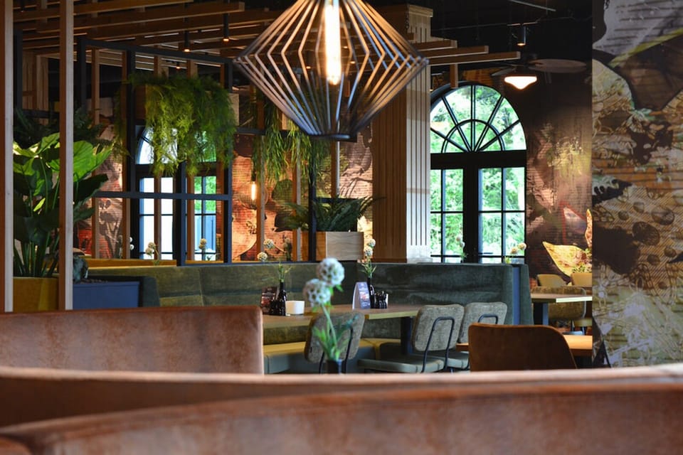 Soak up the stylish vibe under sculptural lighting and tall windows.