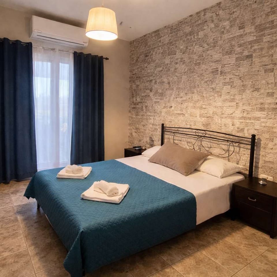 Comfortable Bedroom with Soft Lighting and Stone Wall Details
