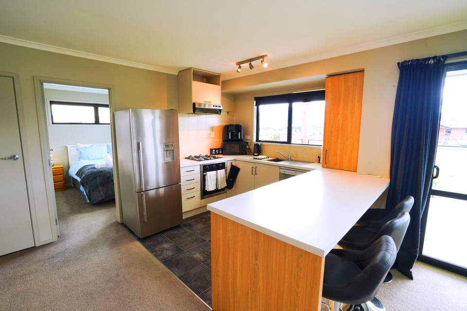 Fully equipped modern kitchen with everything needed for home cooking during your stay.