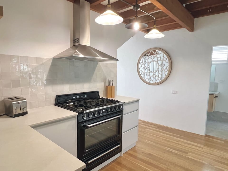 Electric Smeg oven and gas cooktop.