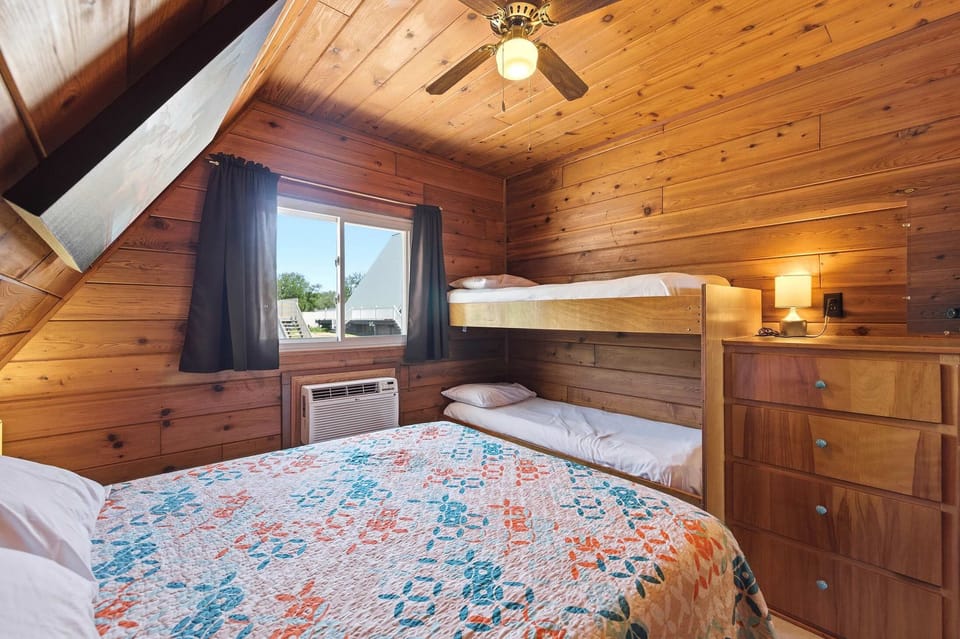 Upstairs sleeping space with bunk beds provides added flexibility for families.