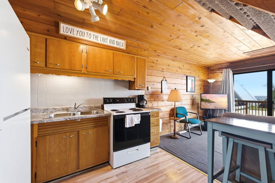 Steps from the deck, a full kitchen keeps meals and snacks convenient.