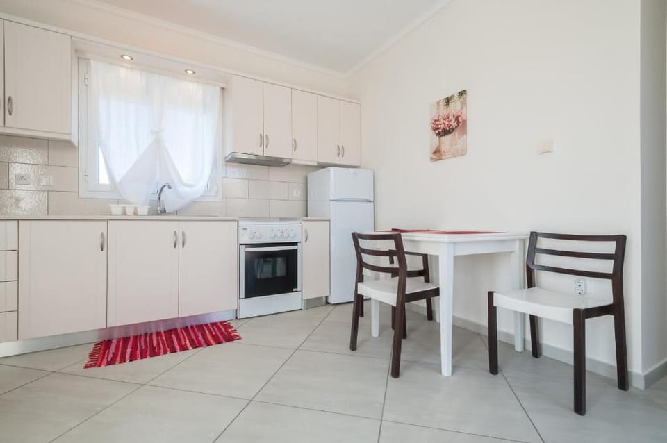 Fully equipped kitchen and dining area with plenty of natural light.