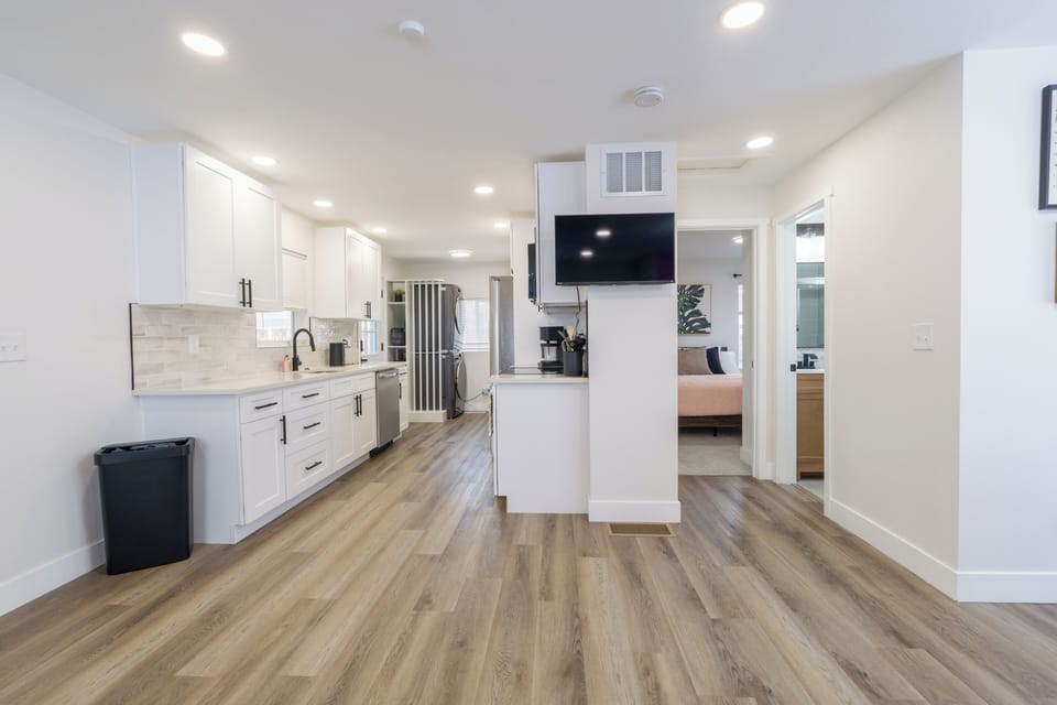 Your bright, modern kitchen flows seamlessly into the open living space, perfect for preparing meals while staying connected to your group.