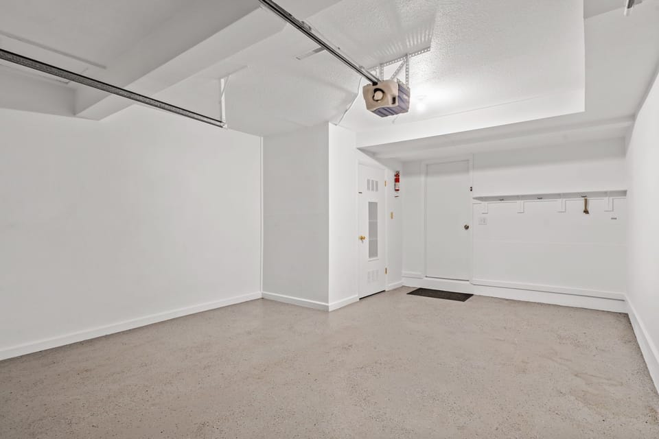 Step into your own spacious basement retreat with exposed beam ceilings and plenty of room to make it yours. The concrete floors and clean white walls create an industrial-chic vibe perfect for a home office, workshop, or entertainment space.