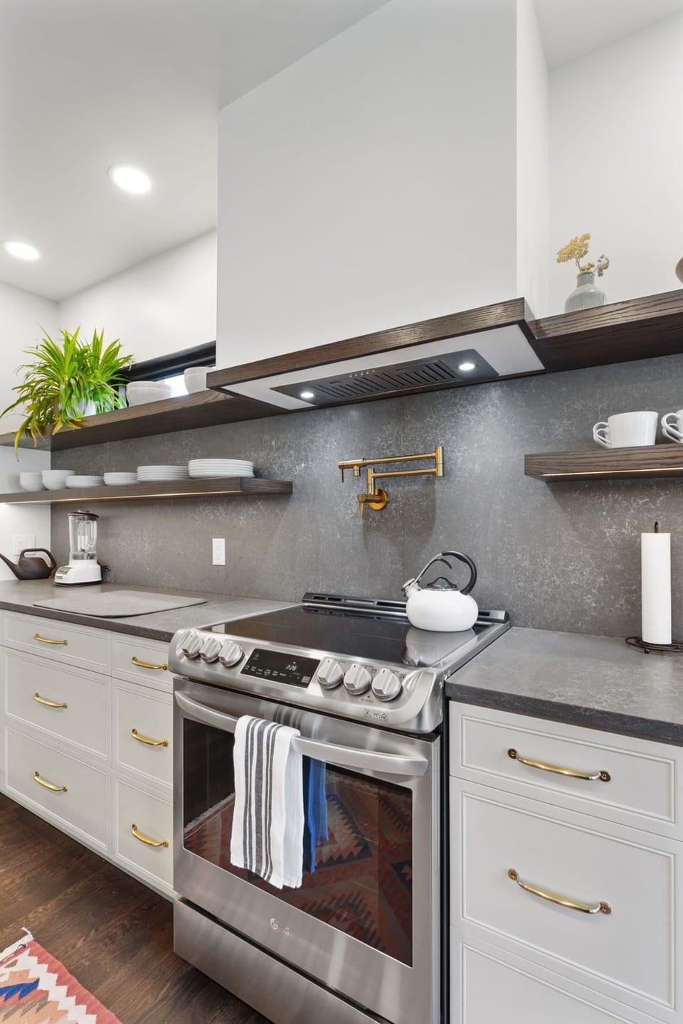 Cook your favorite meals in this modern kitchen with sleek countertops, quality appliances, and thoughtful touches that make you feel at home.