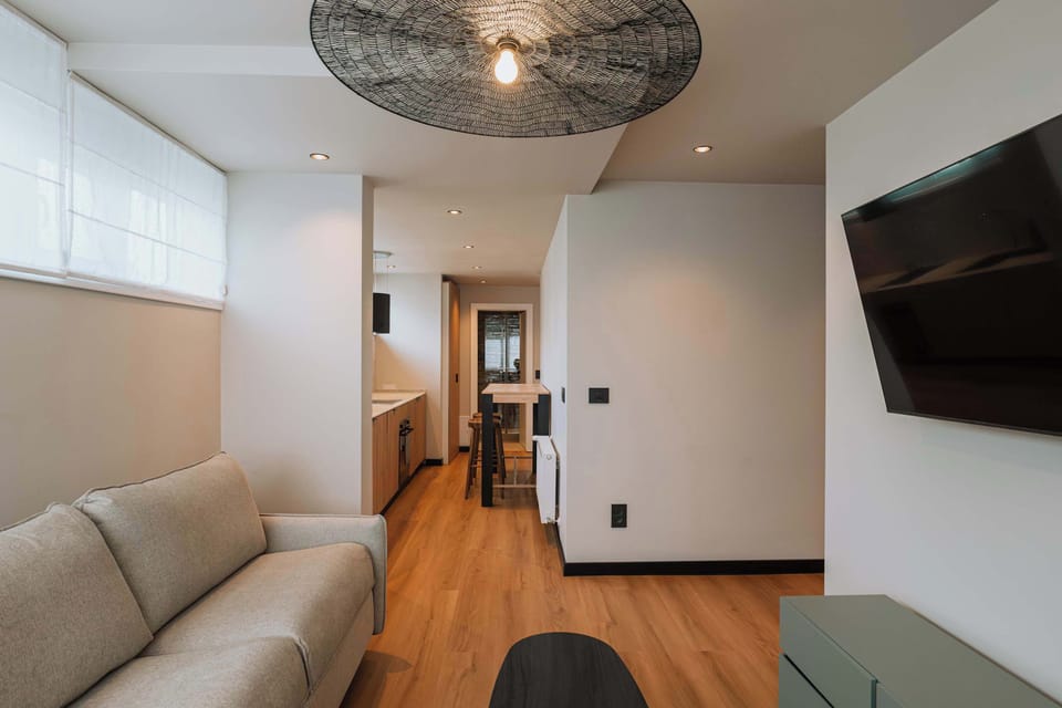 Apartment | Living area | 60-inch TV with cable channels