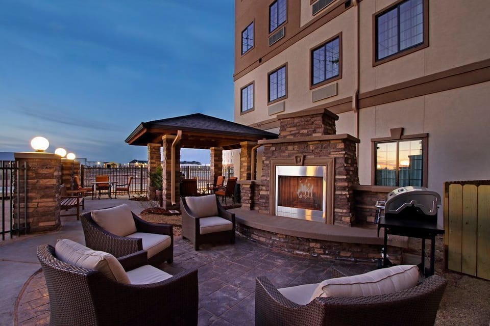 Outdoor lounge area with fire pit and patio seating.