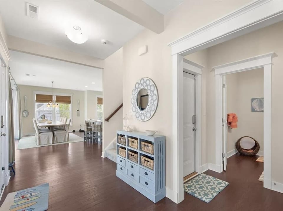 A welcoming entryway filled with natural light and coastal charm.
