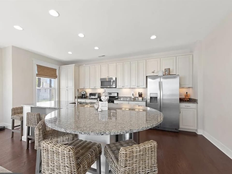 Gather around the large island for meals and casual chats in this bright, modern kitchen.