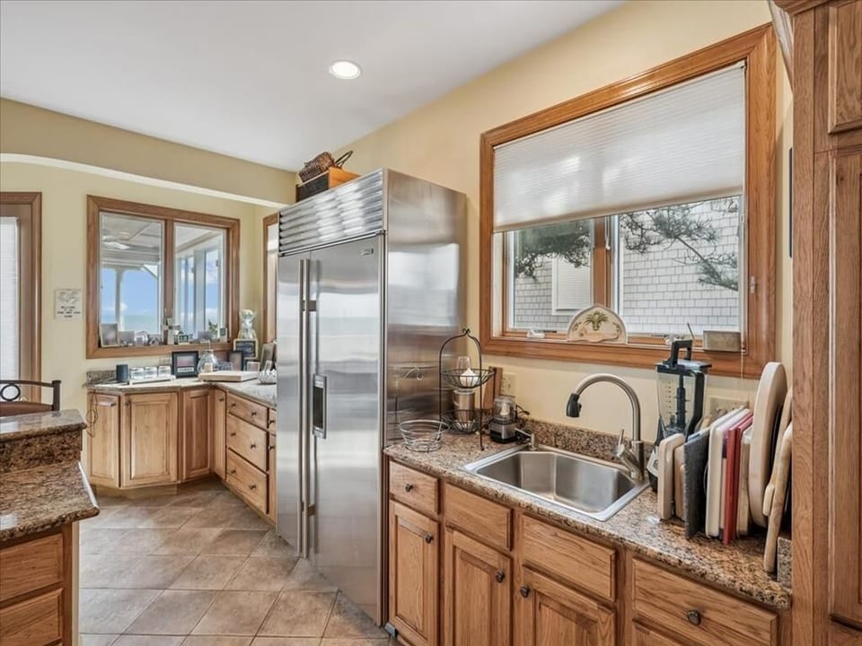 Bright and airy, this kitchen offers stunning views through expansive windows, allowing natural light to flood the space.