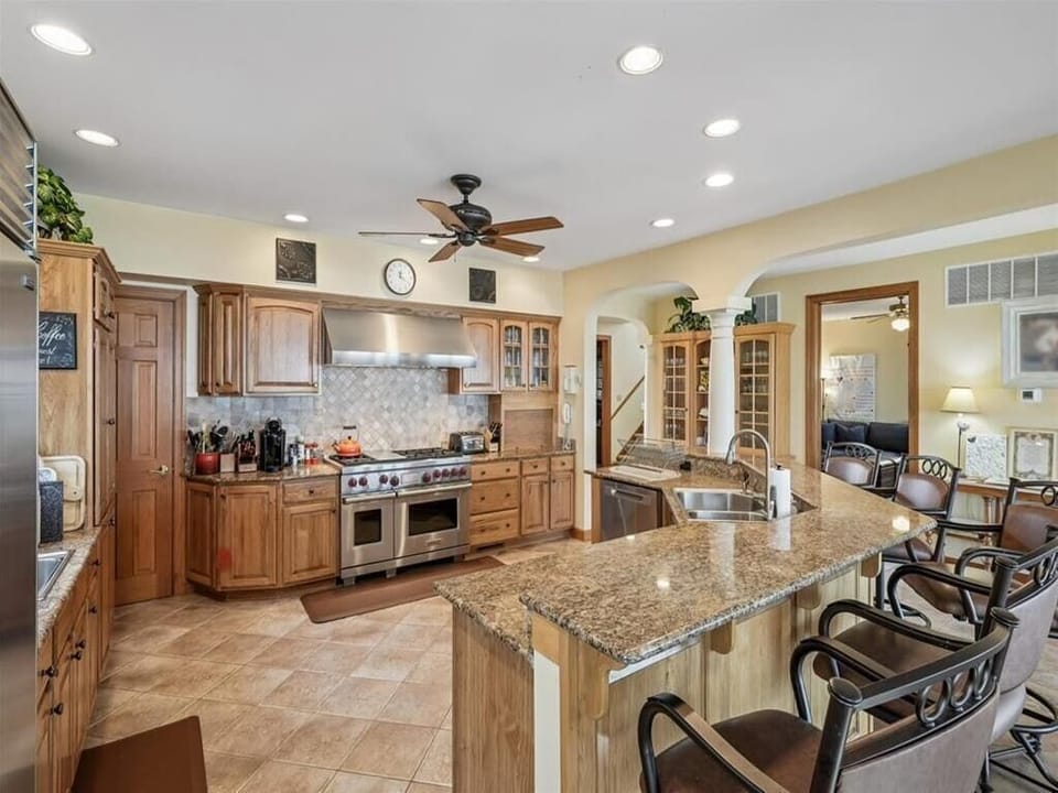 The open-concept kitchen is designed for entertaining, with ample seating and a stylish layout that blends functionality and aesthetics.