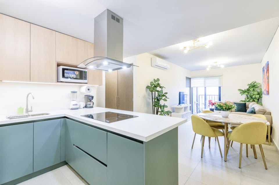 Deluxe Suite, City View | Living area | 60-inch Smart TV with digital channels, streaming services