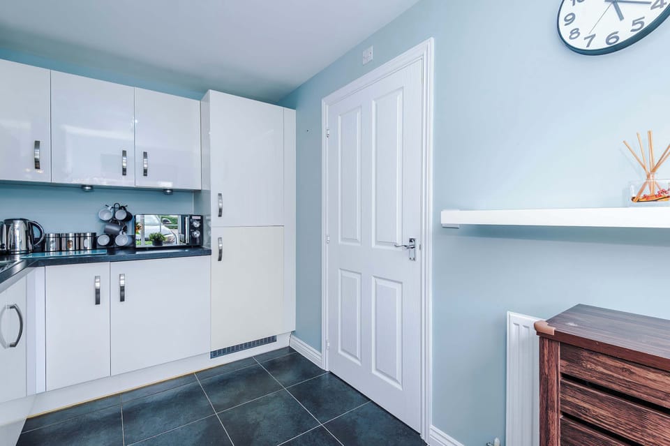 Cook with ease in a bright, modern kitchen featuring white cabinetry, granite counters, and stainless steel appliances. Thoughtful details and clean design make meal prep simple and stylish.