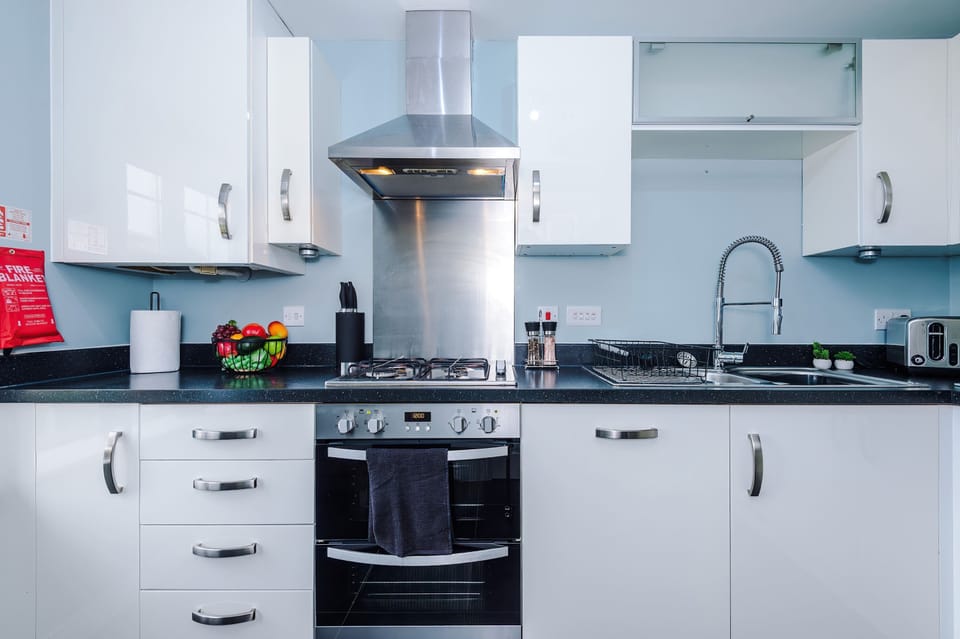 A bright, modern kitchen with sleek cabinetry, stainless steel finishes, and fresh accents. Perfectly designed for cooking, entertaining, and creating memorable meals during your stay.