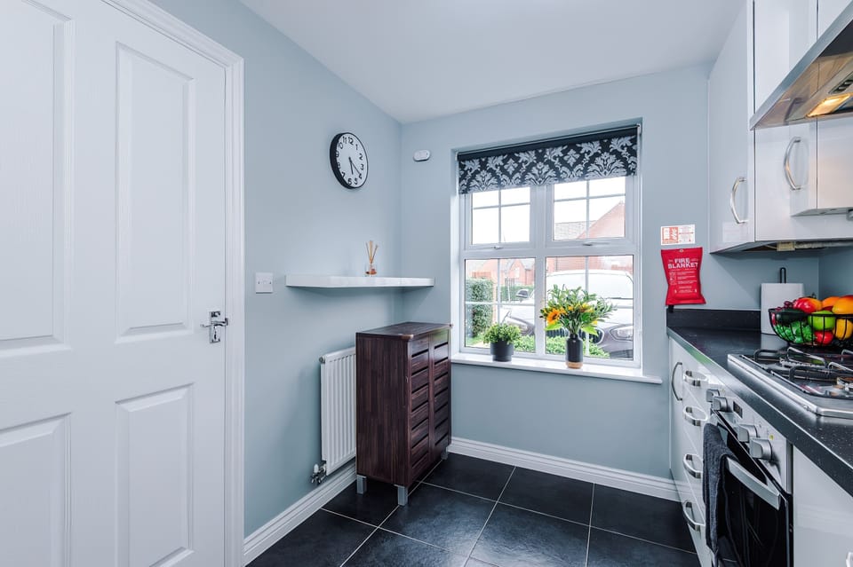 A chic kitchen with sleek cabinets, dark counters, and modern appliances. Minimalist décor and smart layout create the perfect space for cooking, entertaining, and enjoying your stay
