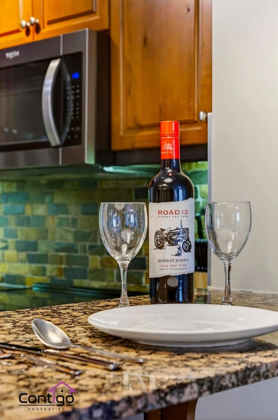 Complete kitchen with microwave stove and granite island ideal for extended stays in our family friendly Canmore vacation rental