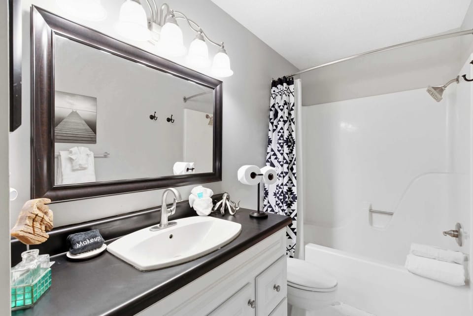 A single vanity & shower/tub combo await in the first full bath​