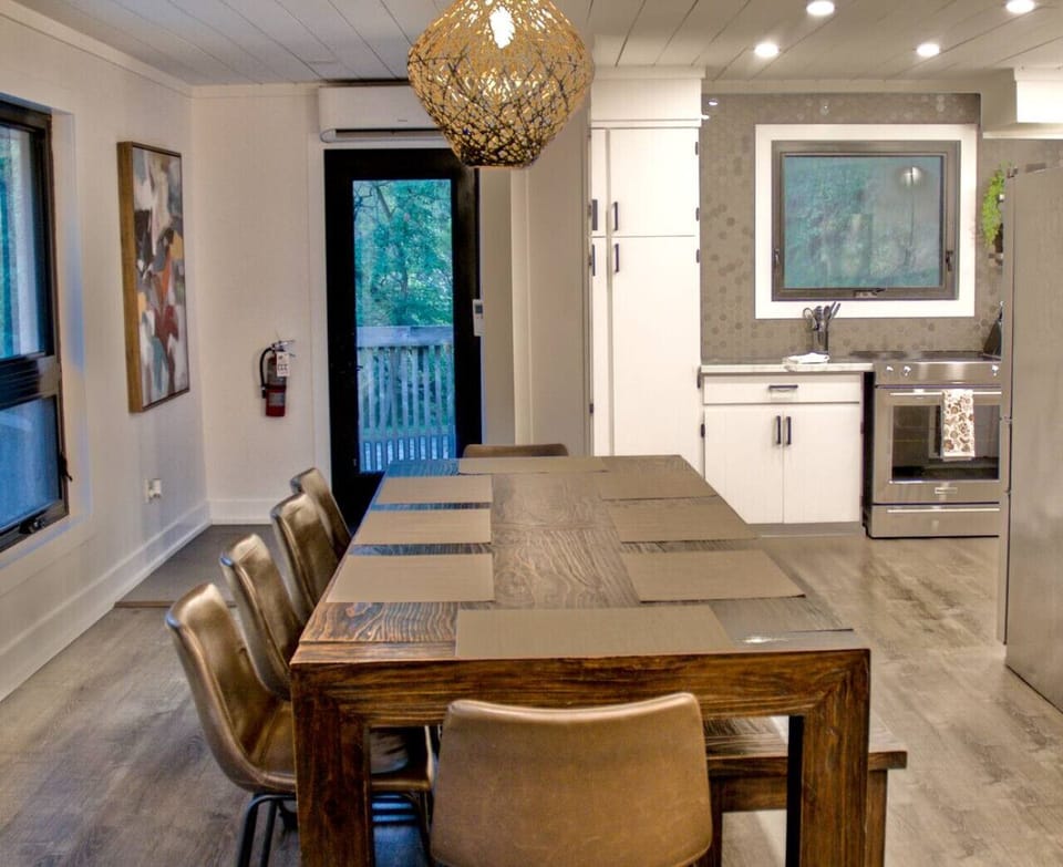 Open concept dining area and table directly next to the kitchen in main chalet