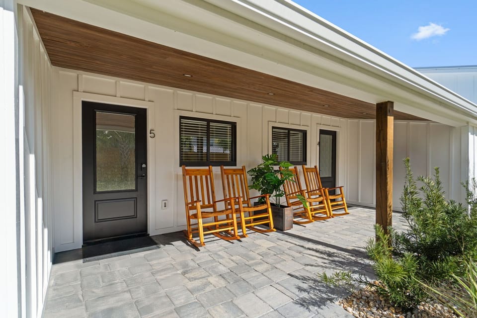 Small Serenity 5 has a covered front patio overlooking the fenced in yard - rock away with drink in hand watching the kids play!