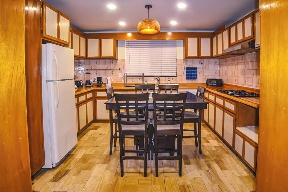 Complete space with fridge, table, and cabinets to store everything you need.