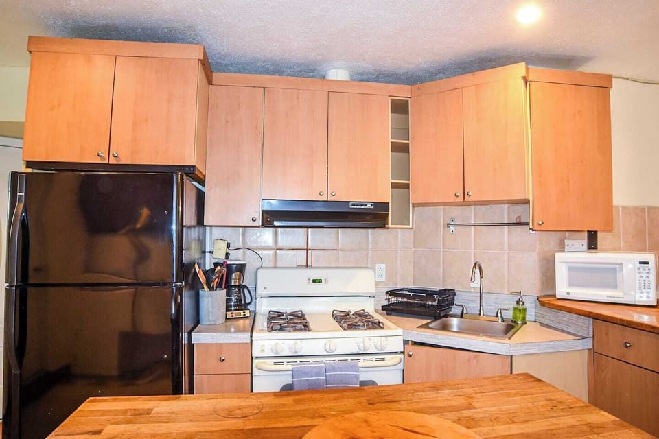 Wood countertops and gas stove bring a warm, practical touch for your favorite recipes.