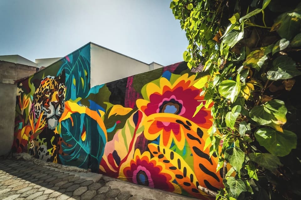 Vibrant, bold murals; a jungle cat lurks amidst tropical flowers.