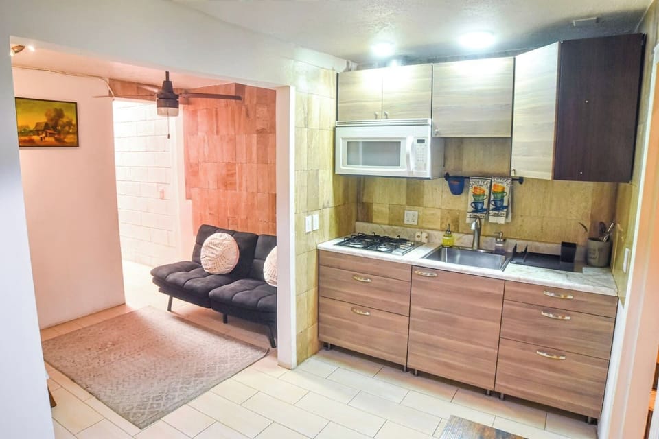 Practical design connecting kitchen and living area, creating a comfortable space to cook and socialize.