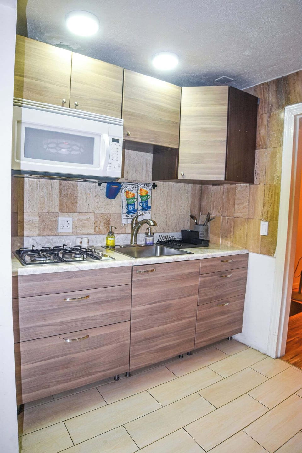 Compact modern kitchen with stove and microwave, ready for you to cook your favorite meals.