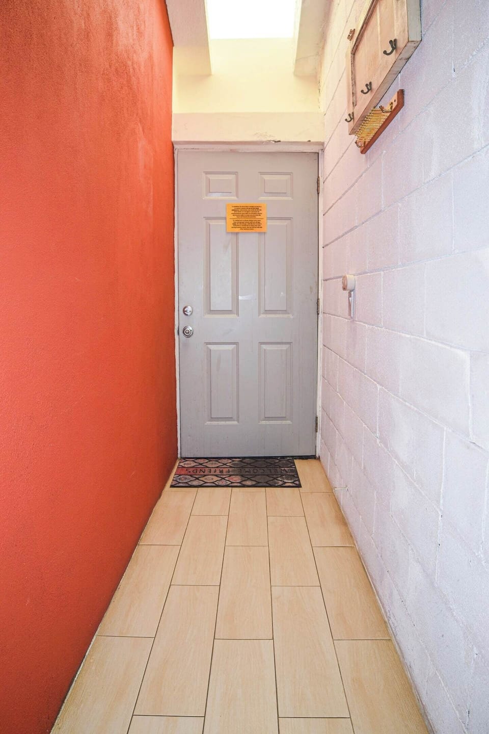 Main entrance with secure door and colorful details that warmly welcome your stay.