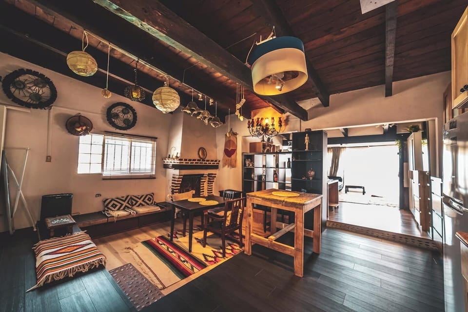 Living room with a futon sofa and flat screen TV is bonus bedroom space.