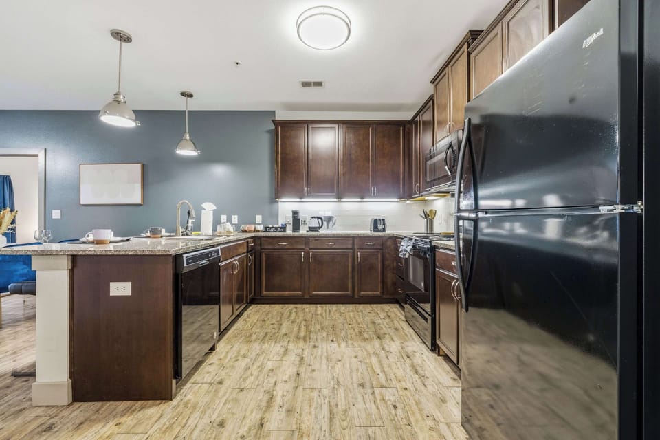 Kitchen with stainless steel appliances and breakfast bar