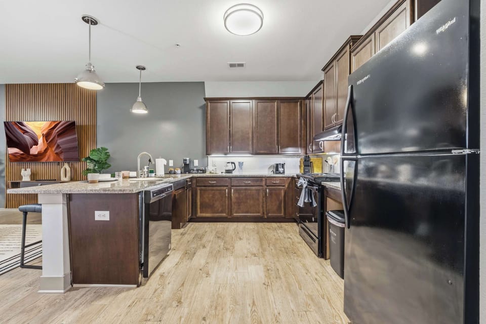 Kitchen with stainless steel appliances and breakfast bar