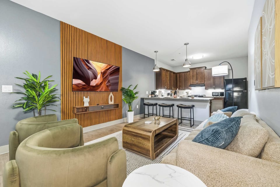 Modern living room with smart TV and open-concept kitchen