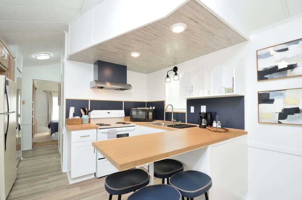 Spacious kitchen w/ large island & modern lighting, perfect for group meals